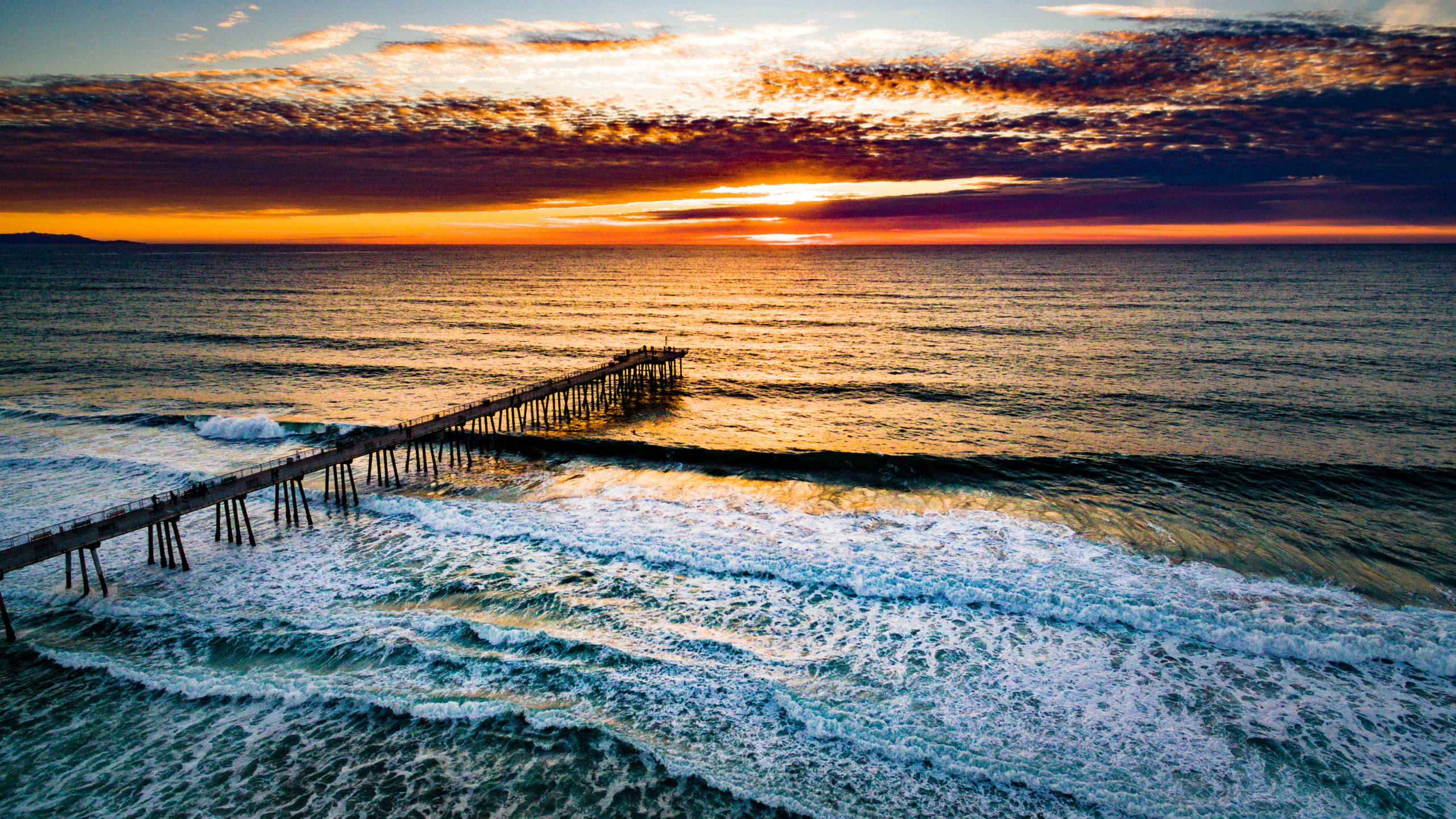 Aerial sunset view over Hermosa Beach Pier and the Pacific Ocean